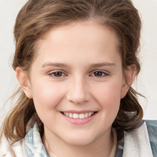 Joyful white child female with medium  brown hair and grey eyes