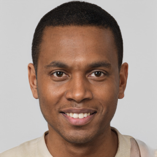 Joyful black young-adult male with short  black hair and brown eyes
