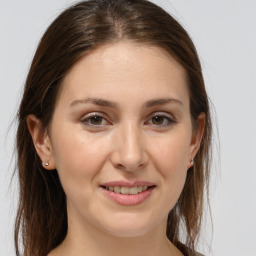 Joyful white young-adult female with medium  brown hair and brown eyes