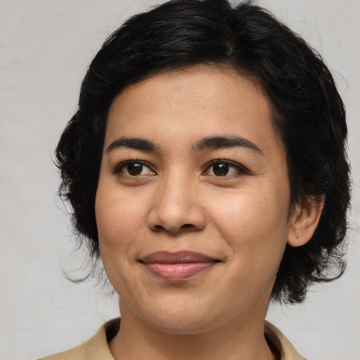 Joyful latino young-adult female with medium  black hair and brown eyes