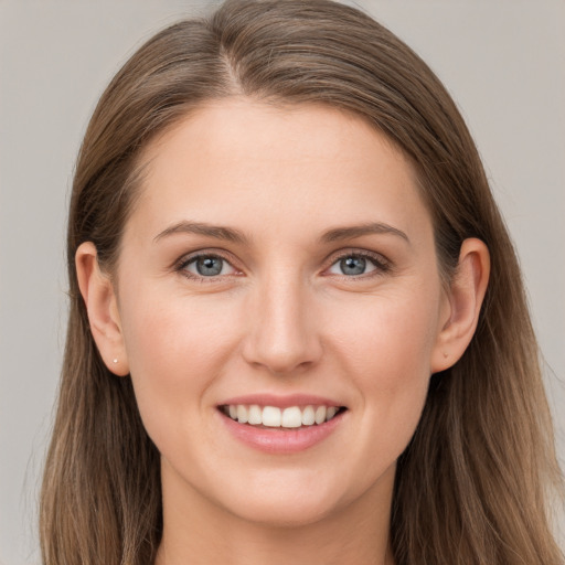 Joyful white young-adult female with long  brown hair and grey eyes