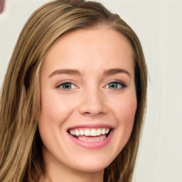 Joyful white young-adult female with long  brown hair and blue eyes