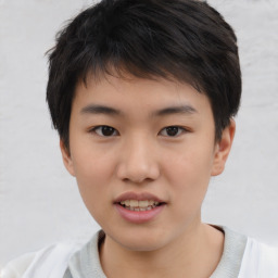 Joyful asian child male with short  brown hair and brown eyes