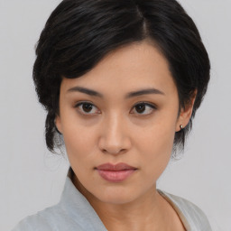 Joyful asian young-adult female with medium  black hair and brown eyes