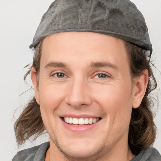 Joyful white adult male with medium  brown hair and grey eyes