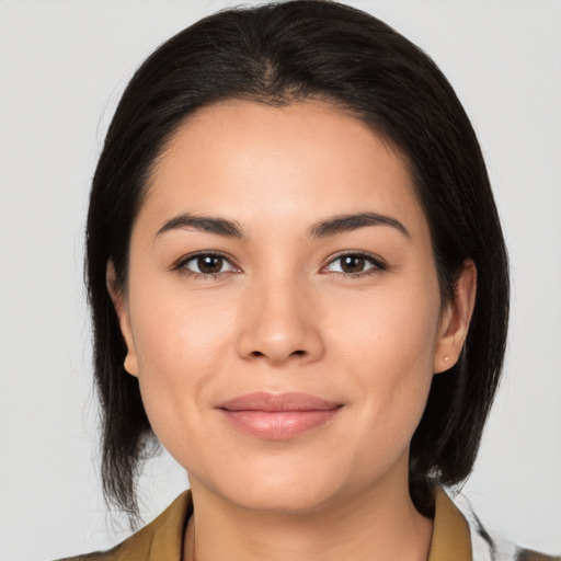 Joyful latino young-adult female with medium  brown hair and brown eyes