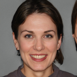 Joyful white adult female with medium  brown hair and brown eyes