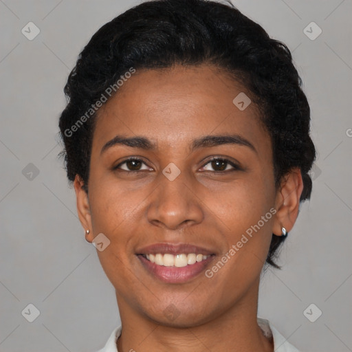 Joyful black young-adult female with short  black hair and brown eyes