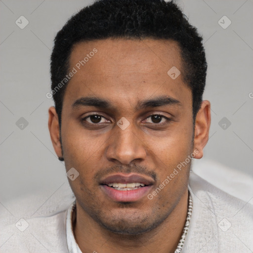 Joyful black young-adult male with short  black hair and brown eyes