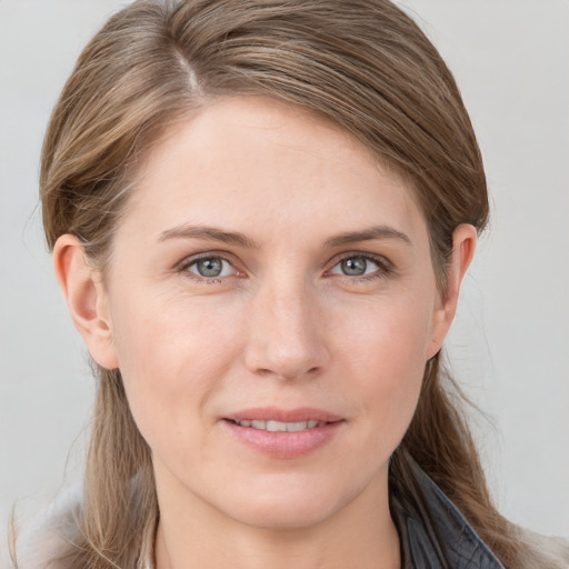 Joyful white young-adult female with long  brown hair and grey eyes