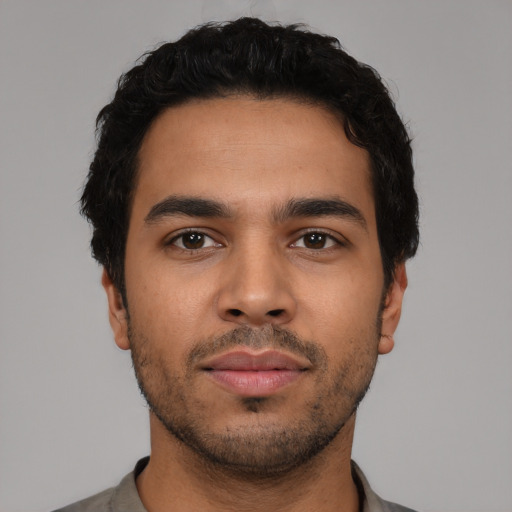 Neutral latino young-adult male with short  black hair and brown eyes