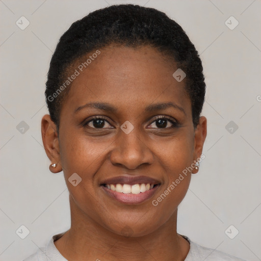 Joyful black young-adult female with short  brown hair and brown eyes