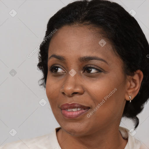 Joyful black adult female with medium  black hair and brown eyes