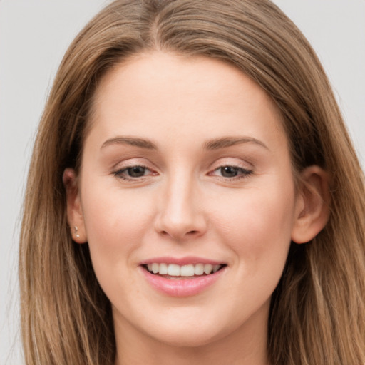 Joyful white young-adult female with long  brown hair and grey eyes