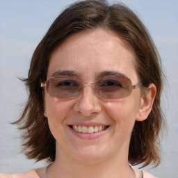 Joyful white young-adult female with medium  brown hair and blue eyes