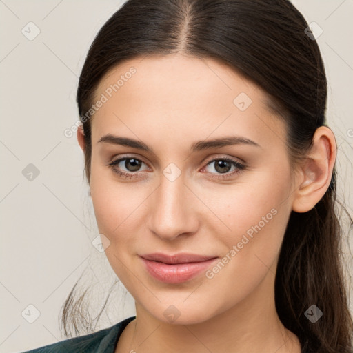 Joyful white young-adult female with long  brown hair and brown eyes