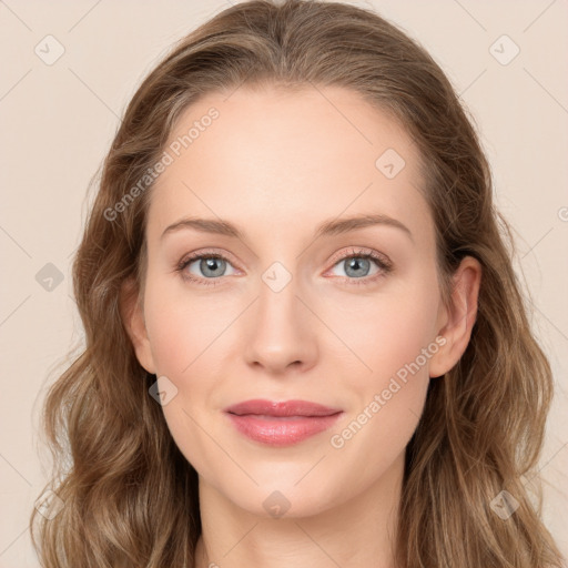 Joyful white young-adult female with long  brown hair and blue eyes