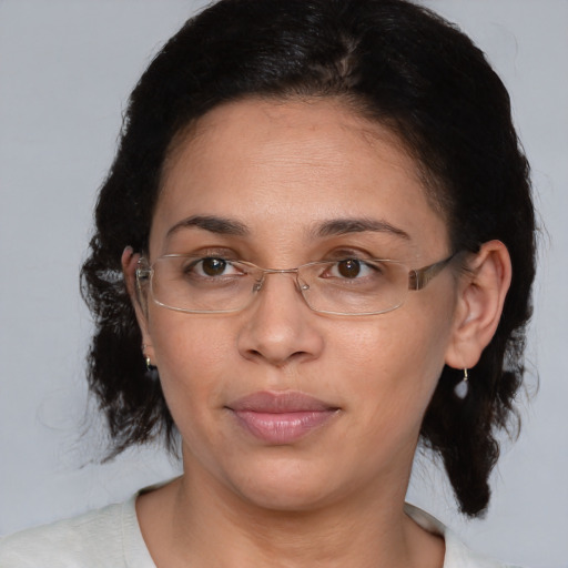 Joyful black adult female with medium  brown hair and brown eyes