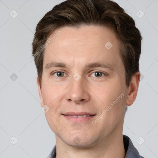 Joyful white adult male with short  brown hair and grey eyes