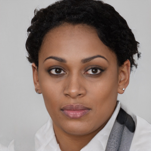 Joyful black young-adult female with short  brown hair and brown eyes