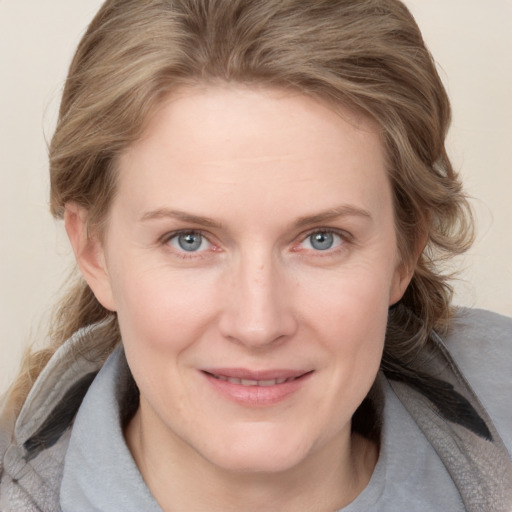 Joyful white young-adult female with medium  brown hair and blue eyes