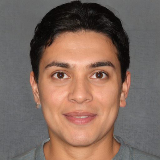 Joyful white young-adult male with short  black hair and brown eyes