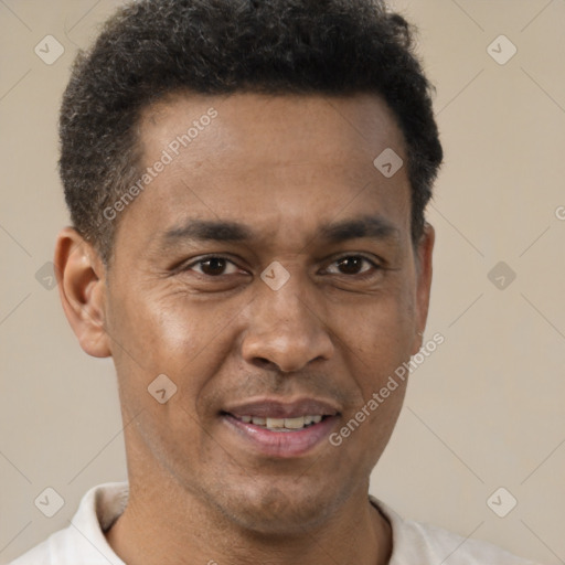 Joyful latino adult male with short  brown hair and brown eyes