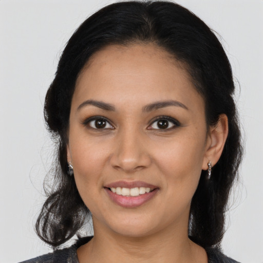 Joyful latino young-adult female with medium  black hair and brown eyes