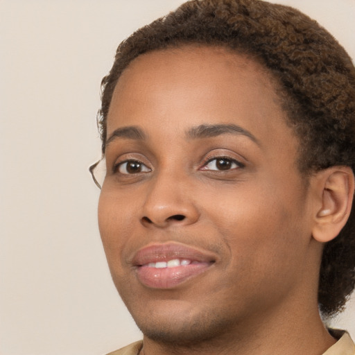 Joyful black young-adult female with short  brown hair and brown eyes