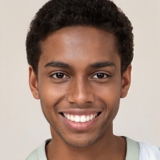 Joyful black young-adult male with short  brown hair and brown eyes