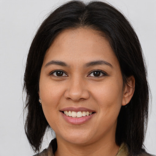 Joyful asian young-adult female with long  brown hair and brown eyes