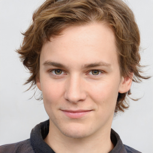 Joyful white young-adult male with medium  brown hair and blue eyes