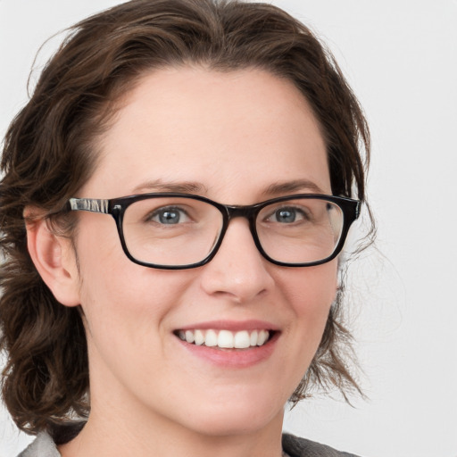 Joyful white young-adult female with medium  brown hair and blue eyes