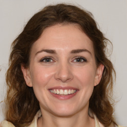 Joyful white young-adult female with medium  brown hair and green eyes