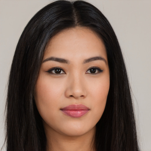 Joyful asian young-adult female with long  black hair and brown eyes