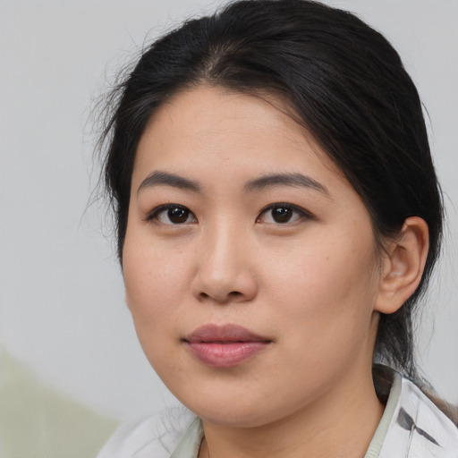 Joyful asian young-adult female with medium  brown hair and brown eyes