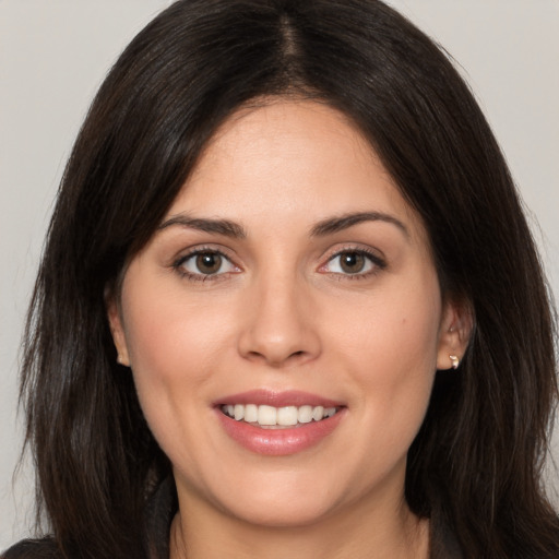 Joyful white young-adult female with long  brown hair and brown eyes