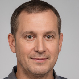 Joyful white adult male with short  brown hair and brown eyes