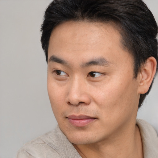 Neutral asian young-adult male with short  brown hair and brown eyes