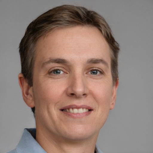 Joyful white adult male with short  brown hair and grey eyes