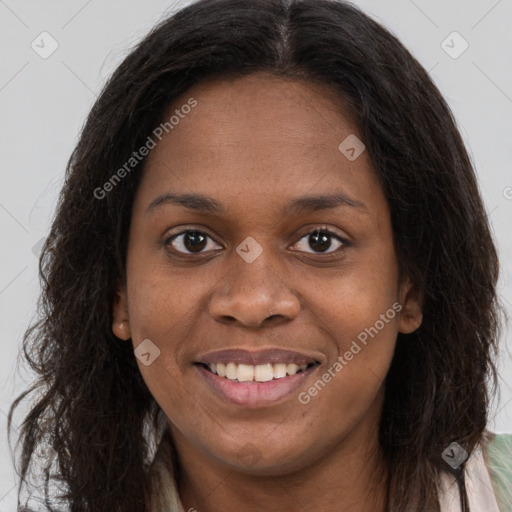 Joyful black young-adult female with long  brown hair and brown eyes