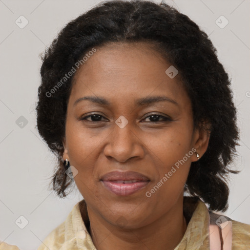 Joyful black adult female with medium  brown hair and brown eyes