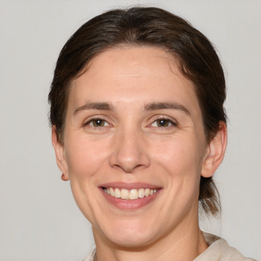 Joyful white adult female with medium  brown hair and brown eyes