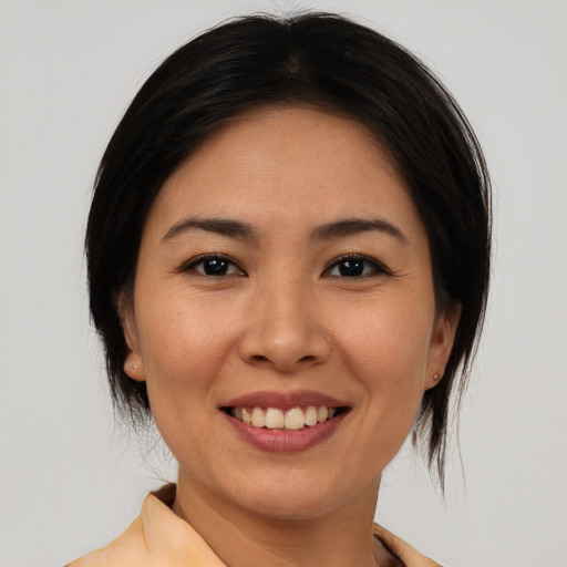 Joyful white young-adult female with medium  brown hair and brown eyes