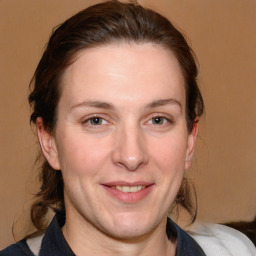 Joyful white adult female with medium  brown hair and grey eyes