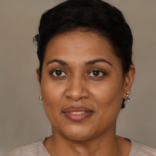 Joyful latino adult female with short  brown hair and brown eyes