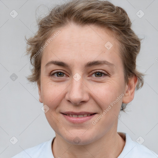 Joyful white adult female with short  brown hair and grey eyes