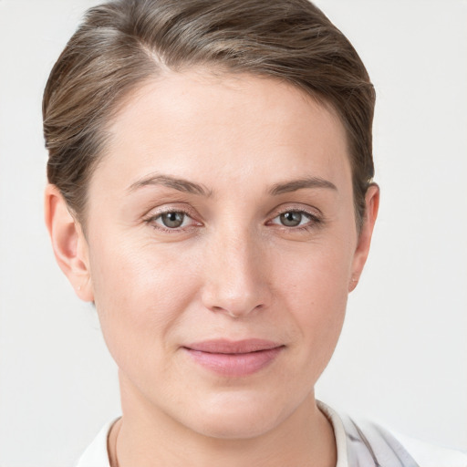 Joyful white young-adult female with short  brown hair and grey eyes