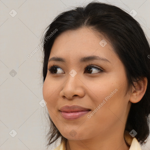 Joyful asian young-adult female with medium  brown hair and brown eyes