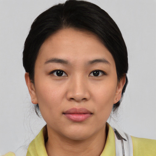 Joyful asian young-adult female with medium  black hair and brown eyes